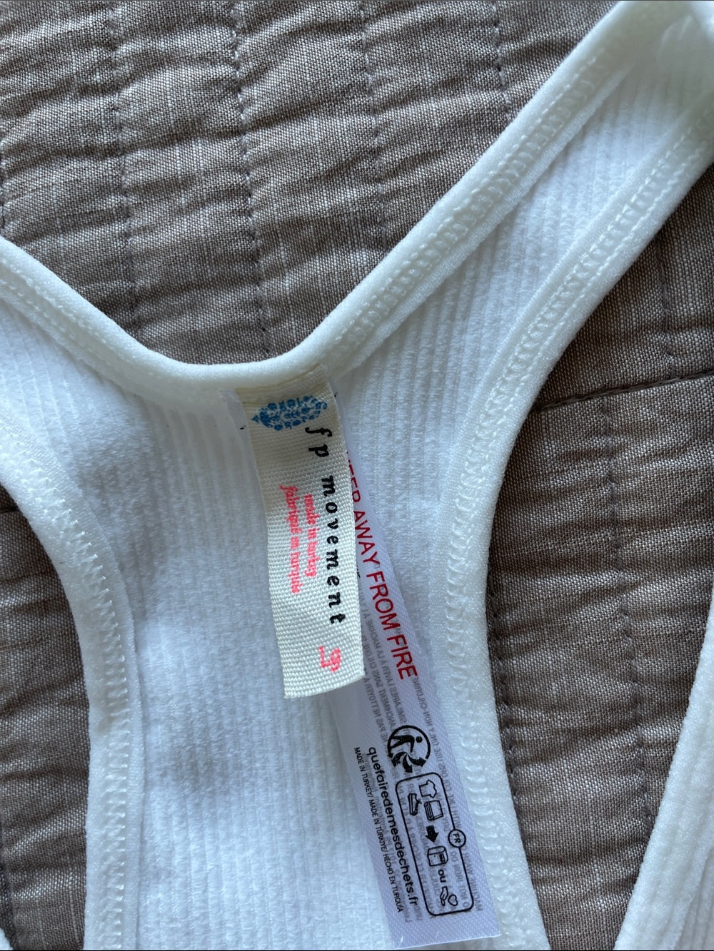 FP Movement by Free People White Ribbed Racerback Tank stretching - Picture 2 of 5